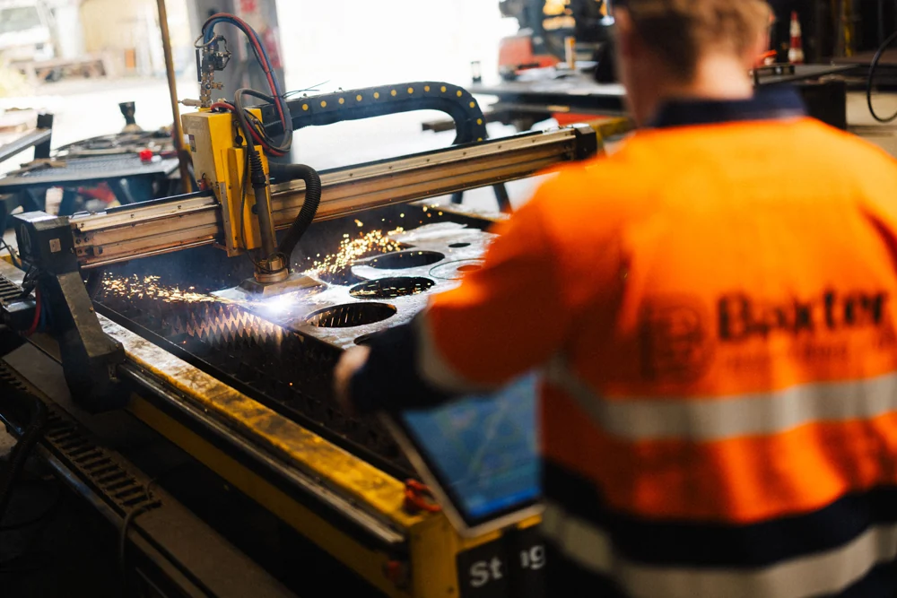 Baxter engineer operating a plasma cutter in the Auckland workshop