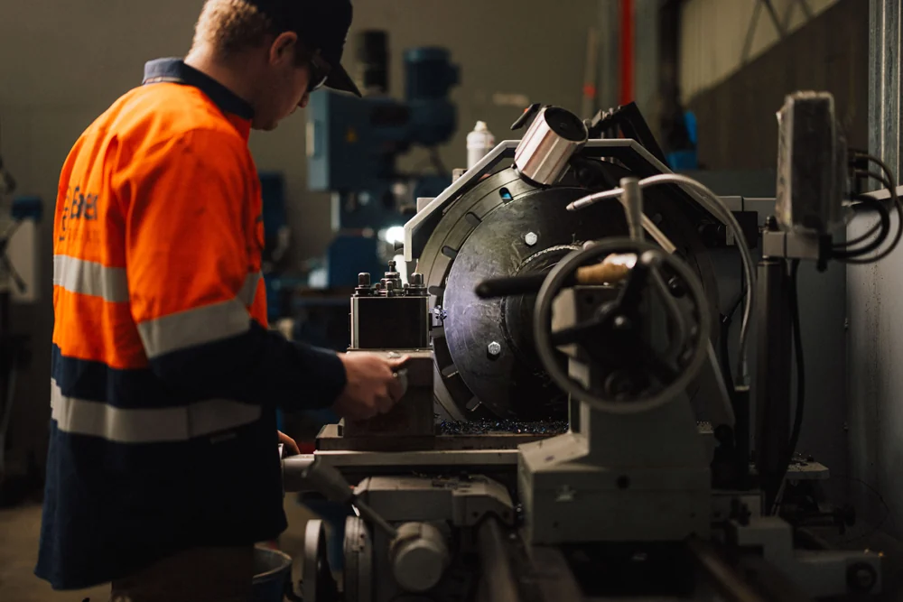 Engineer operating a lathe in the Auckland workshop