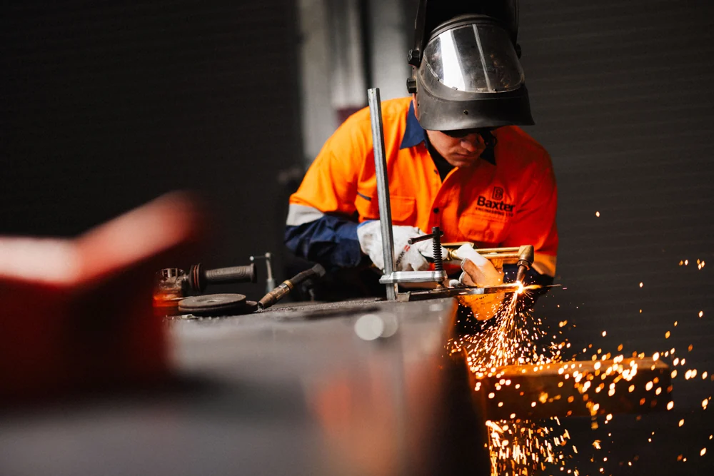 Baxter engineer grinding steel in the Auckland workshop
