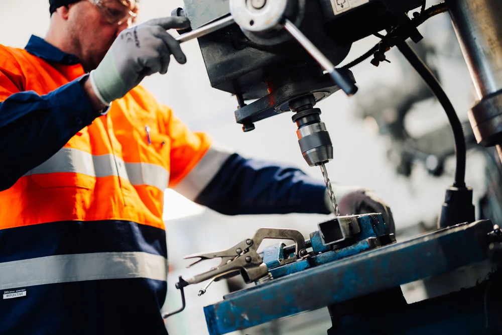 Engineer using a drill in the Rolleston workshop